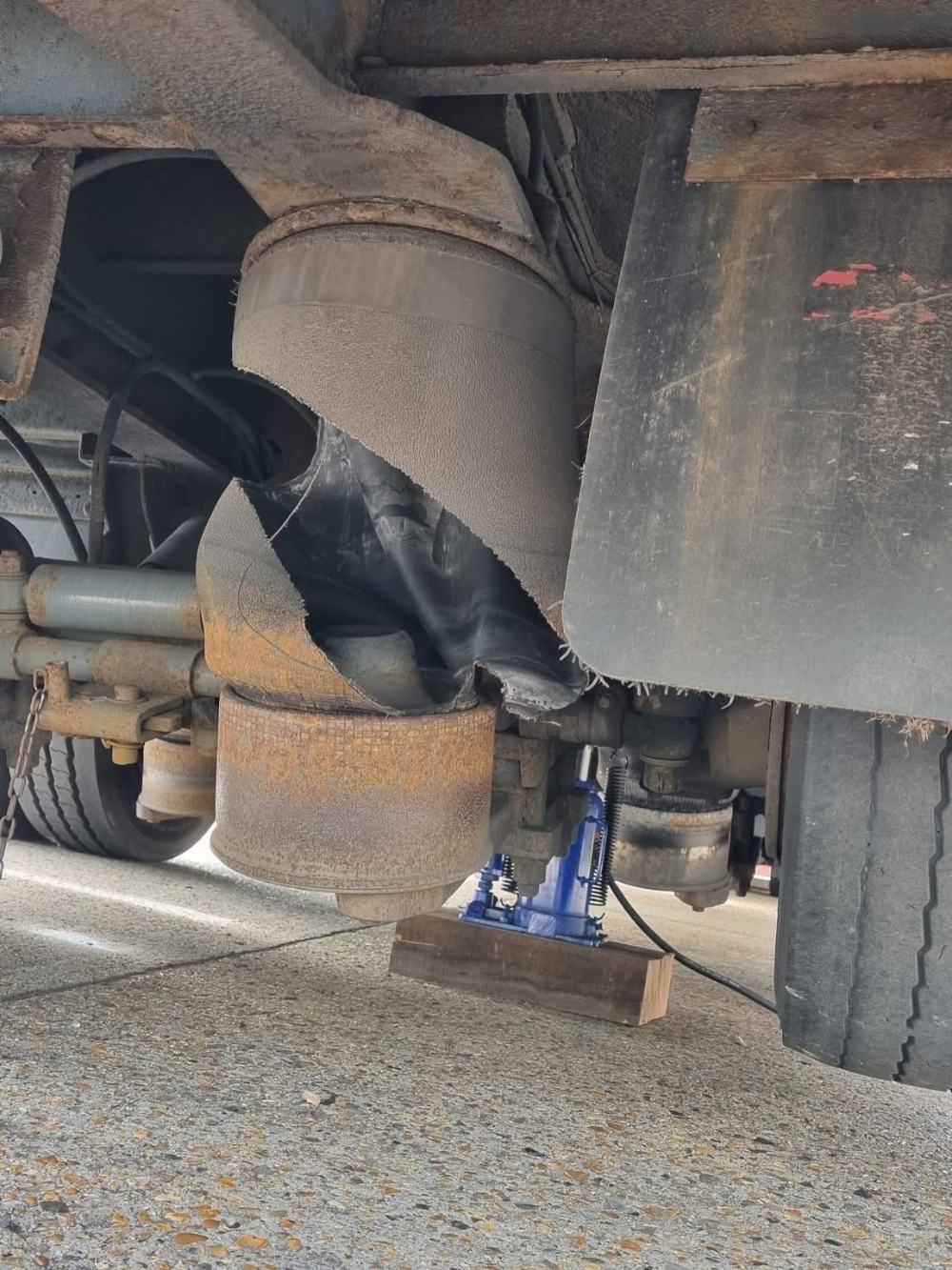 Underneath a trailer during a repair