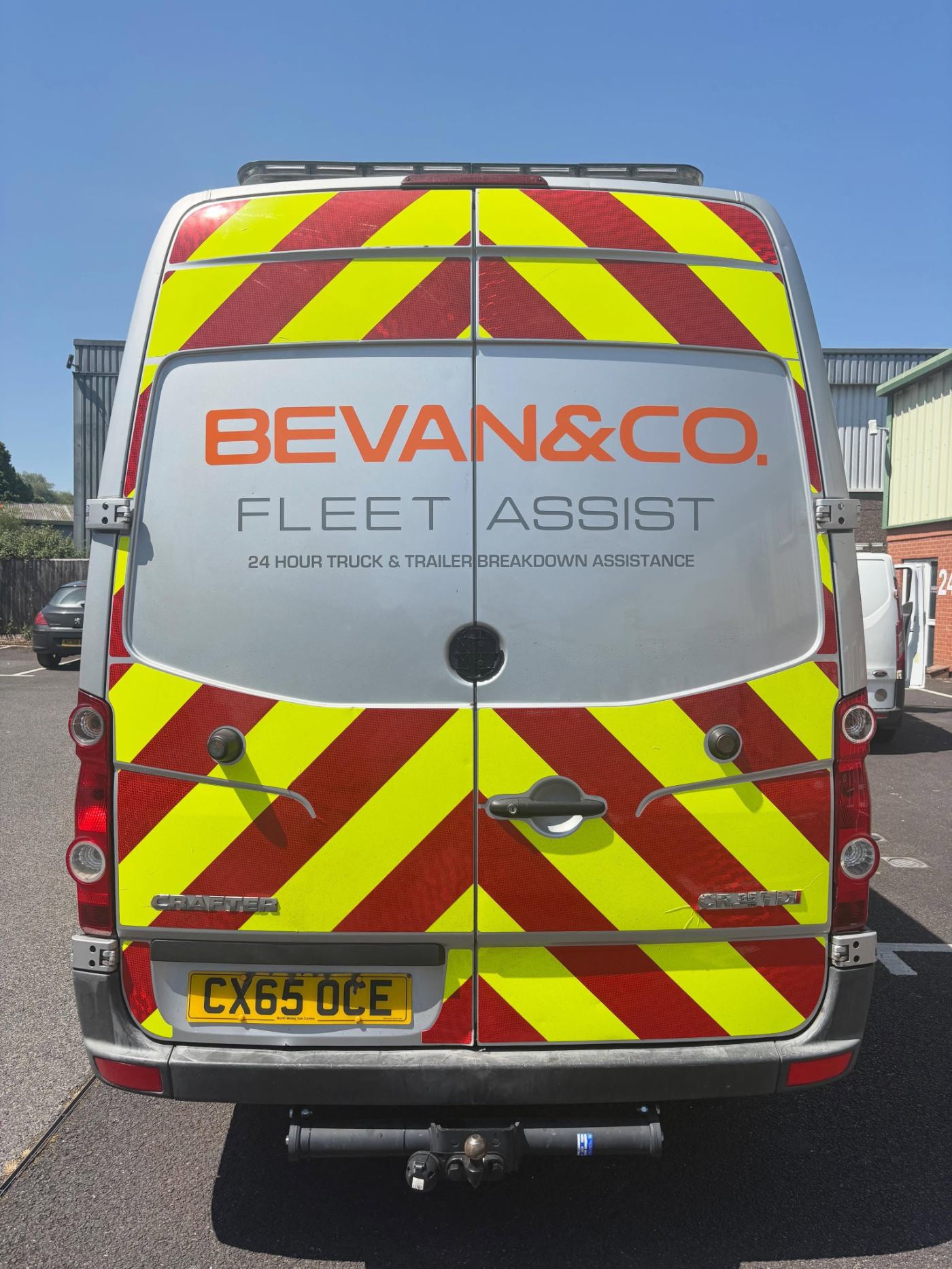 The rear of the Bevan and Co. Fleet Assist van, sign written with red and yellow chevrons